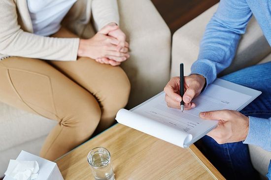 Psychiatrist filling in medical document with patient in Monroe Psychiatrist filling in medical document with patient in Monroe