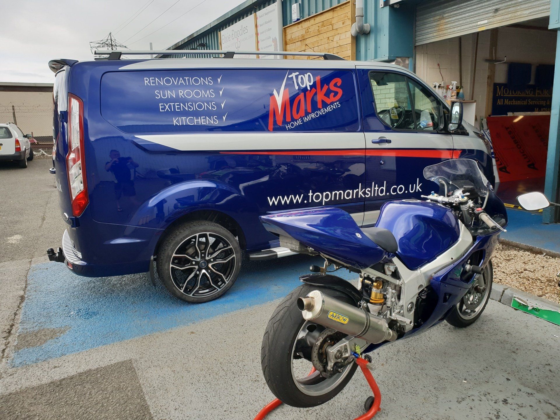 Car decals on Ford Transit Custom van in blue with motorbike