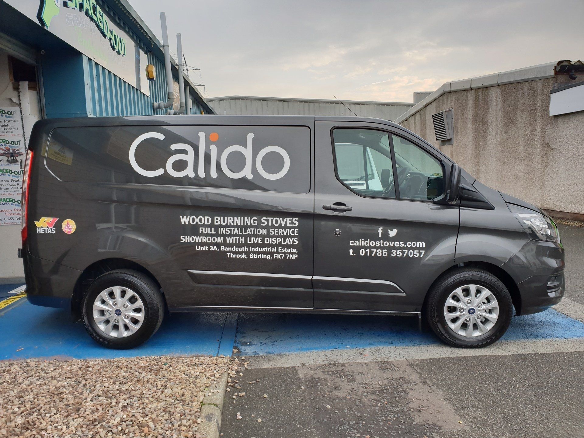 Car signs on a Ford Transit van in grey, side view