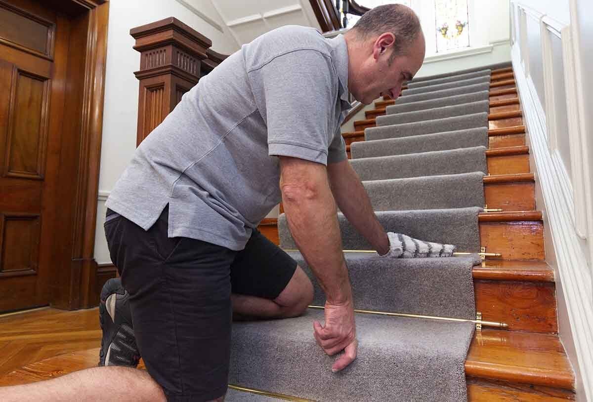 Agitating pre-spray with mitten on office stair carpet