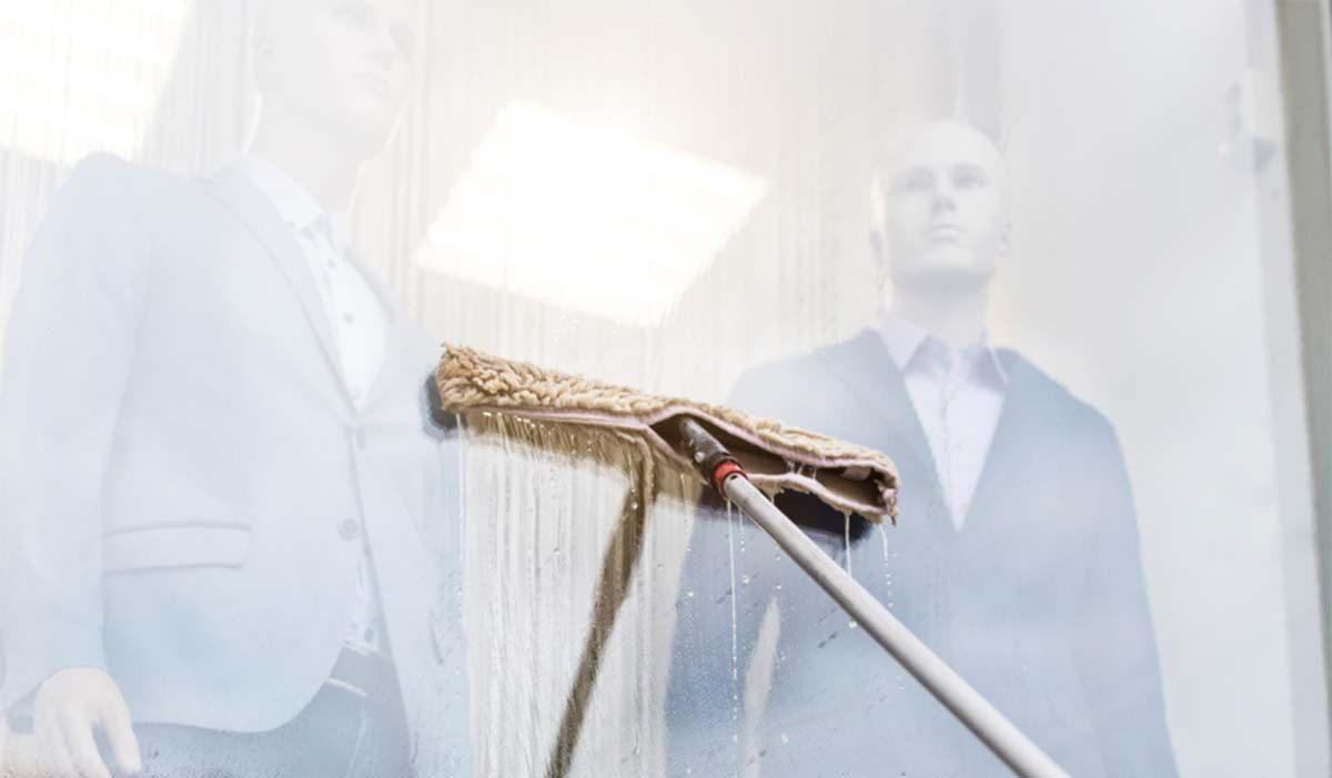 Cleaning clothes shop windows in Leeds