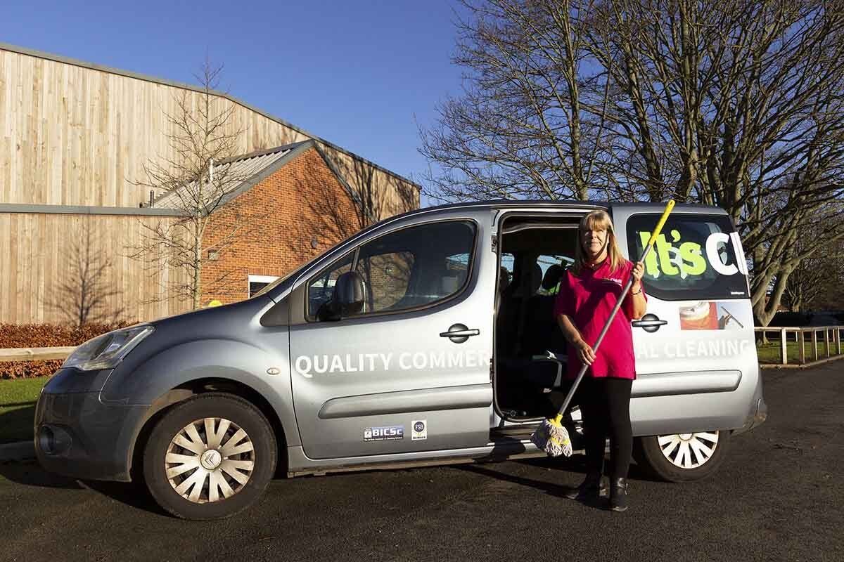Clearer unloading work van outside school sports hall