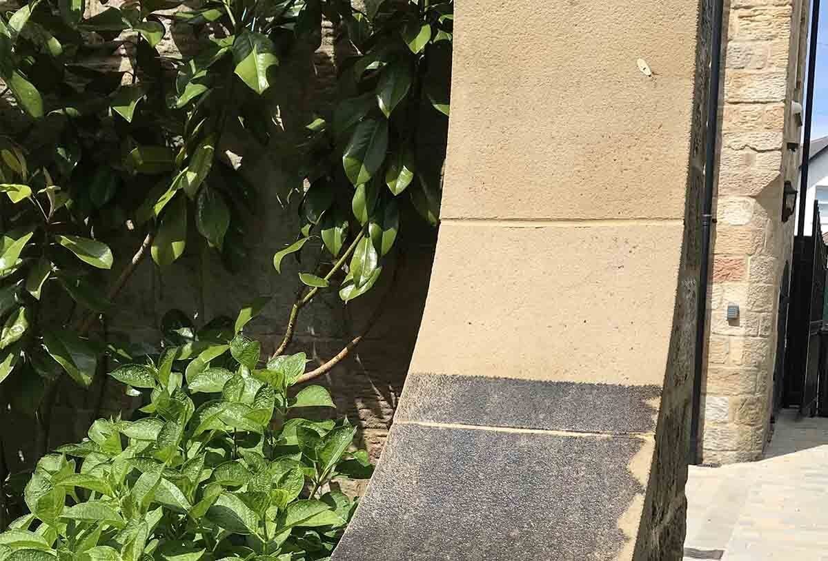 Soft washing coping stones on garden wall