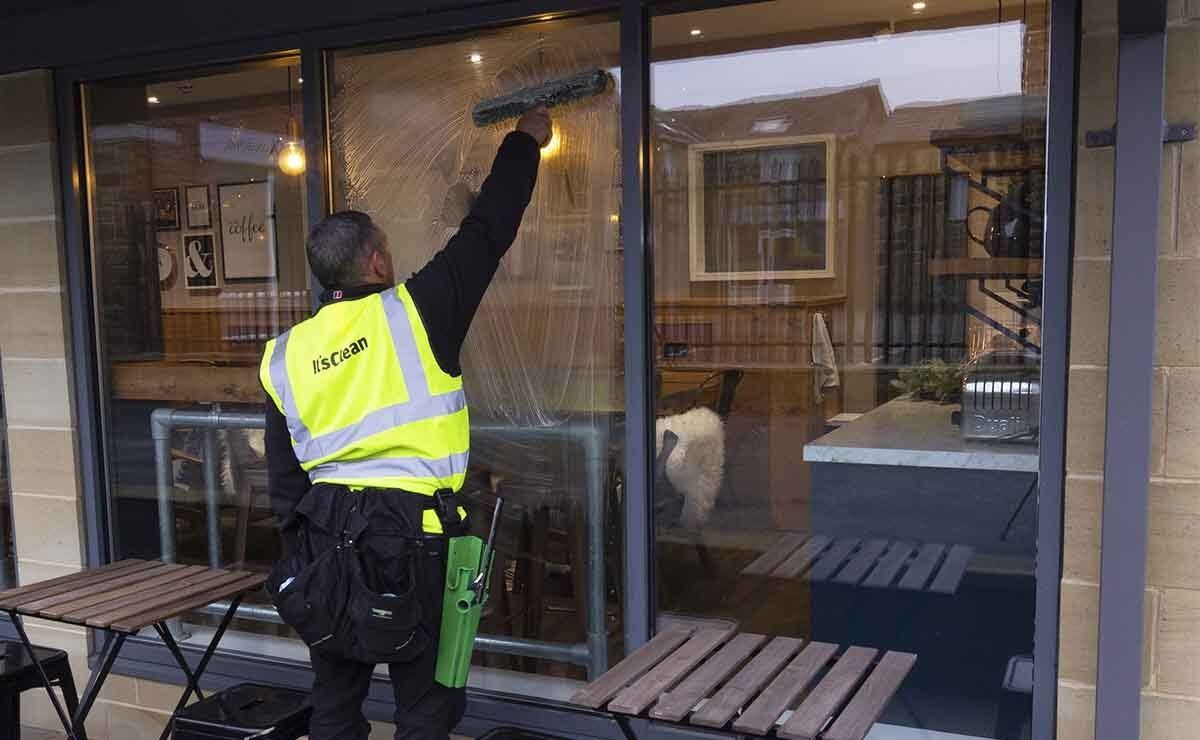 Click here to find out more about our commercial window cleaning services Window cleaner cleaning office cafeteria windows