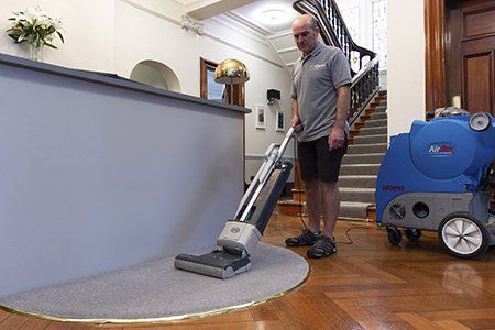 Vacuuming office carpet before Hot Water Extraction cleaning