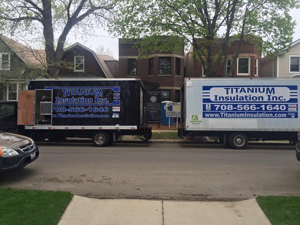 Two titanium insulation trucks are parked on the side of the road