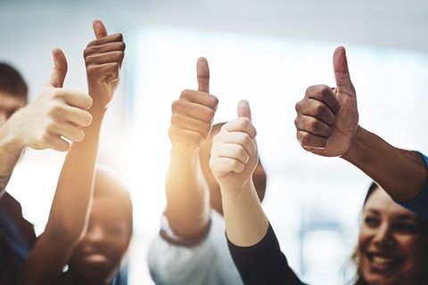A group of employees giving a thumbs up.