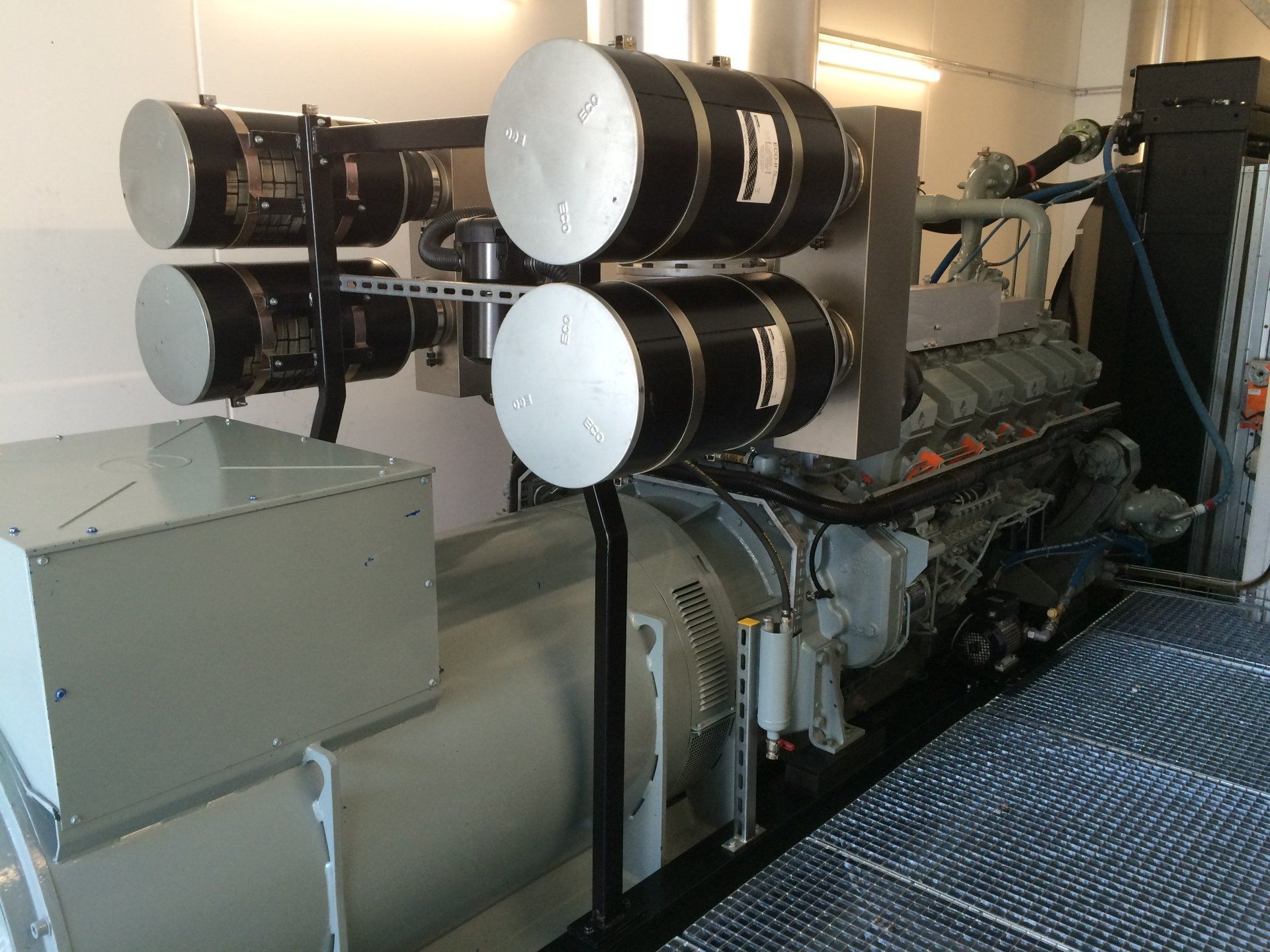 Un gros moteur est assis dans une pièce avec beaucoup de cylindres