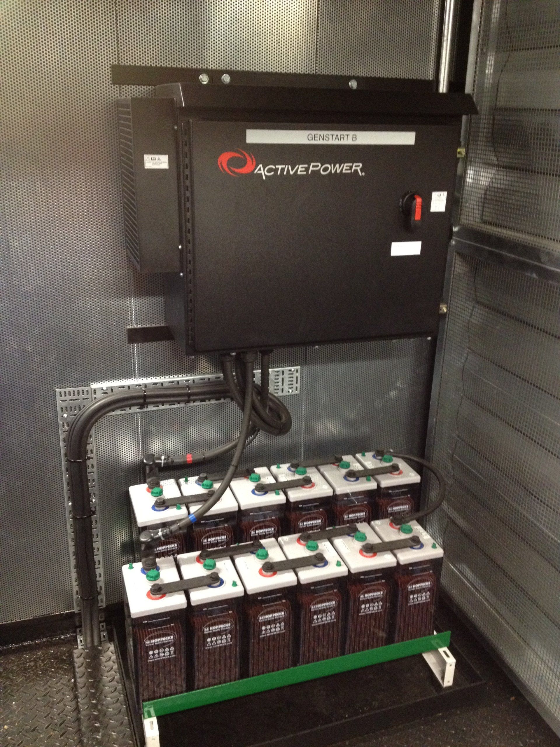 A bunch of batteries are sitting on a cart next to a box that says active power