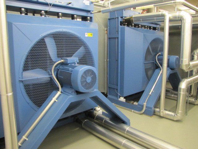 Two blue fans are sitting next to each other in a room