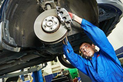 Auto Mechanic At Car Brake Shoes — Grants Pass, OR — Rons Mechanical Service Auto Mechanic At Car Brake Shoes — Grants Pass, OR — Rons Mechanical Service