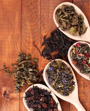 Herbs and dried flowers on wooden spoons used for enema therapy by Hertfordshire Colonics