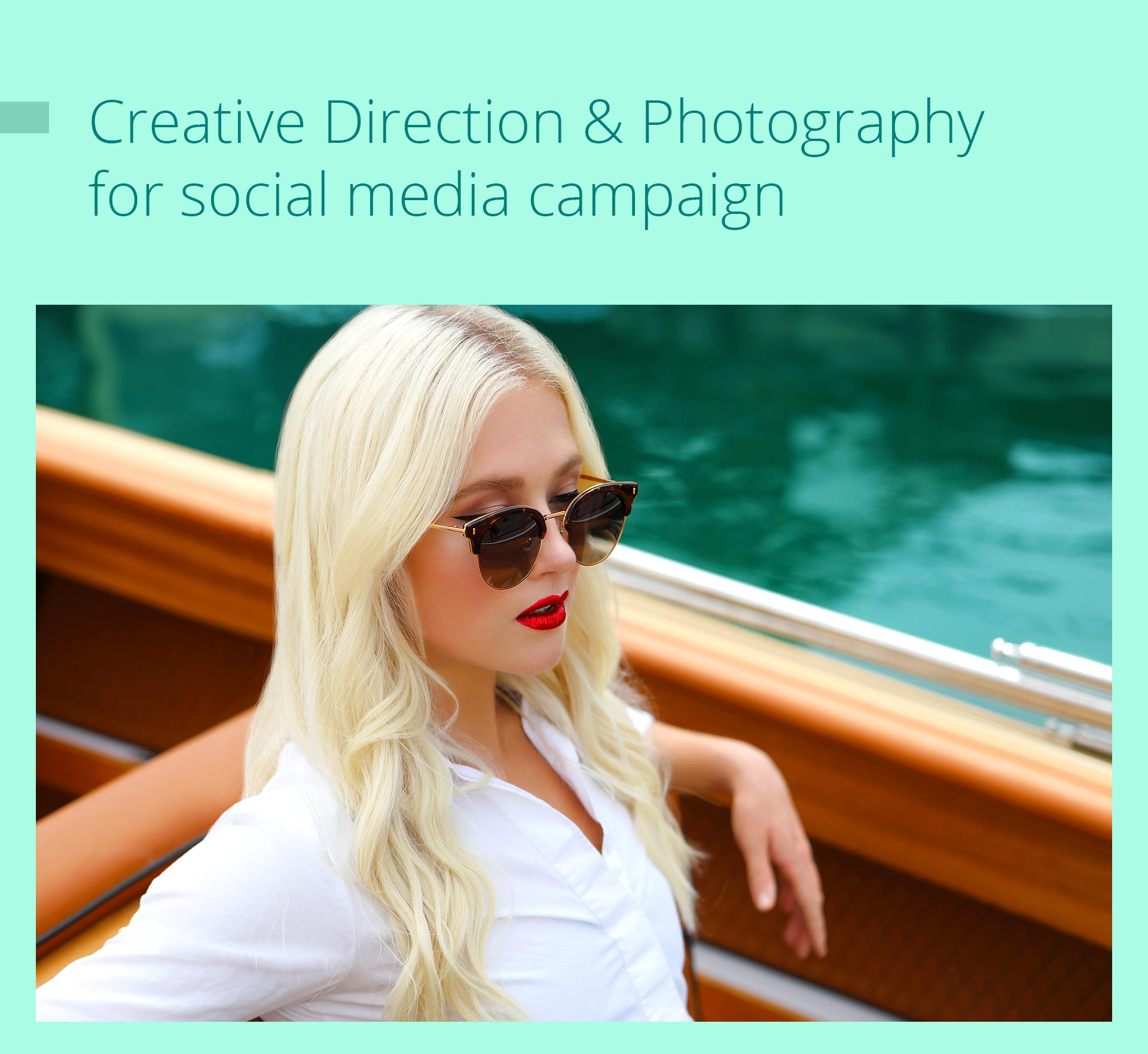 Blonde woman in sunglasses on a boat, red lipstick, white shirt, turquoise water backdrop.