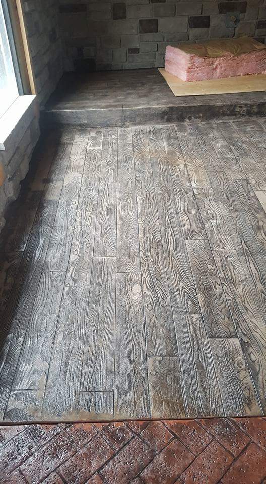 A room with a wooden floor and a fireplace.
