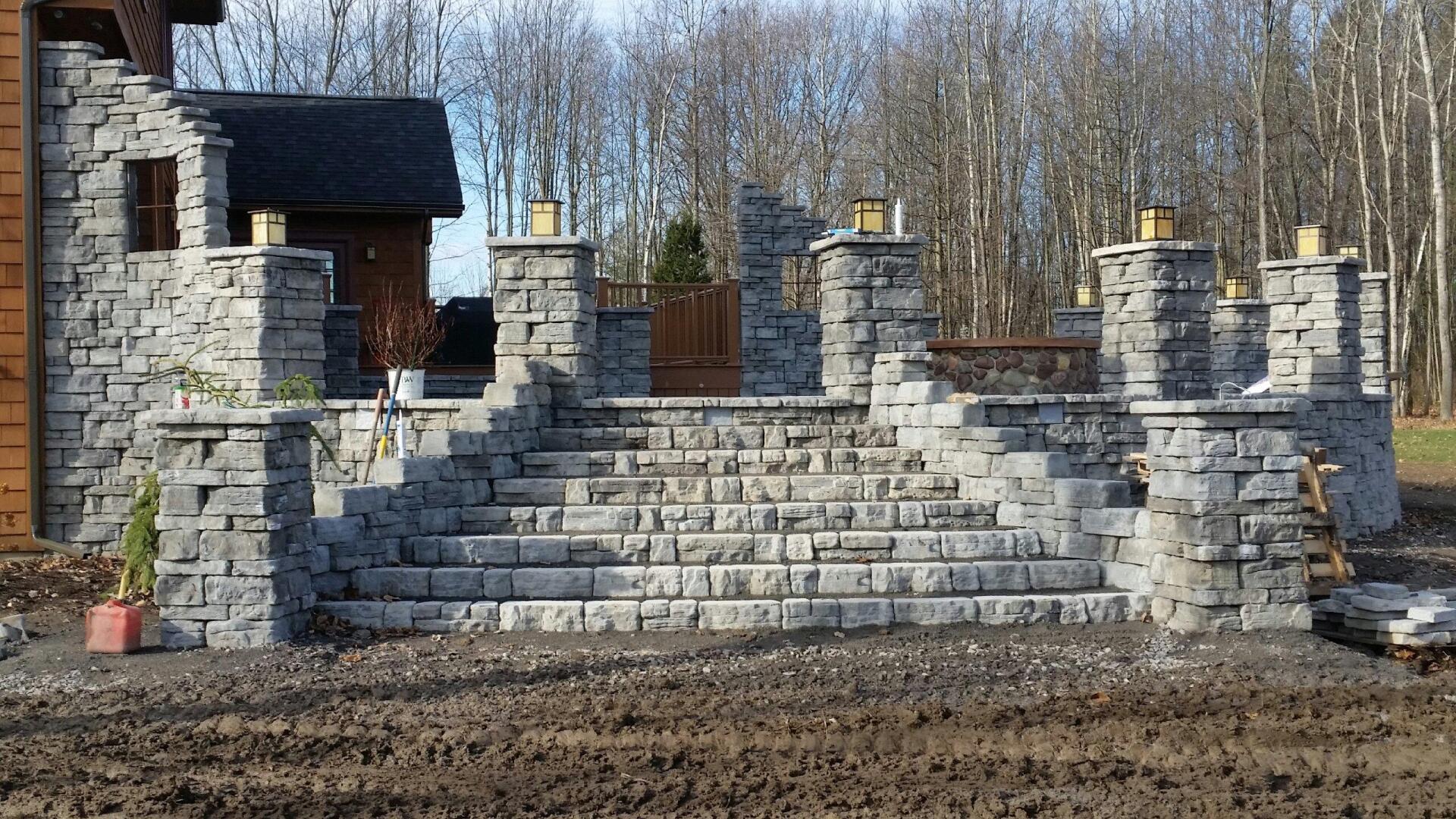 A stone staircase leading up to a house in the woods