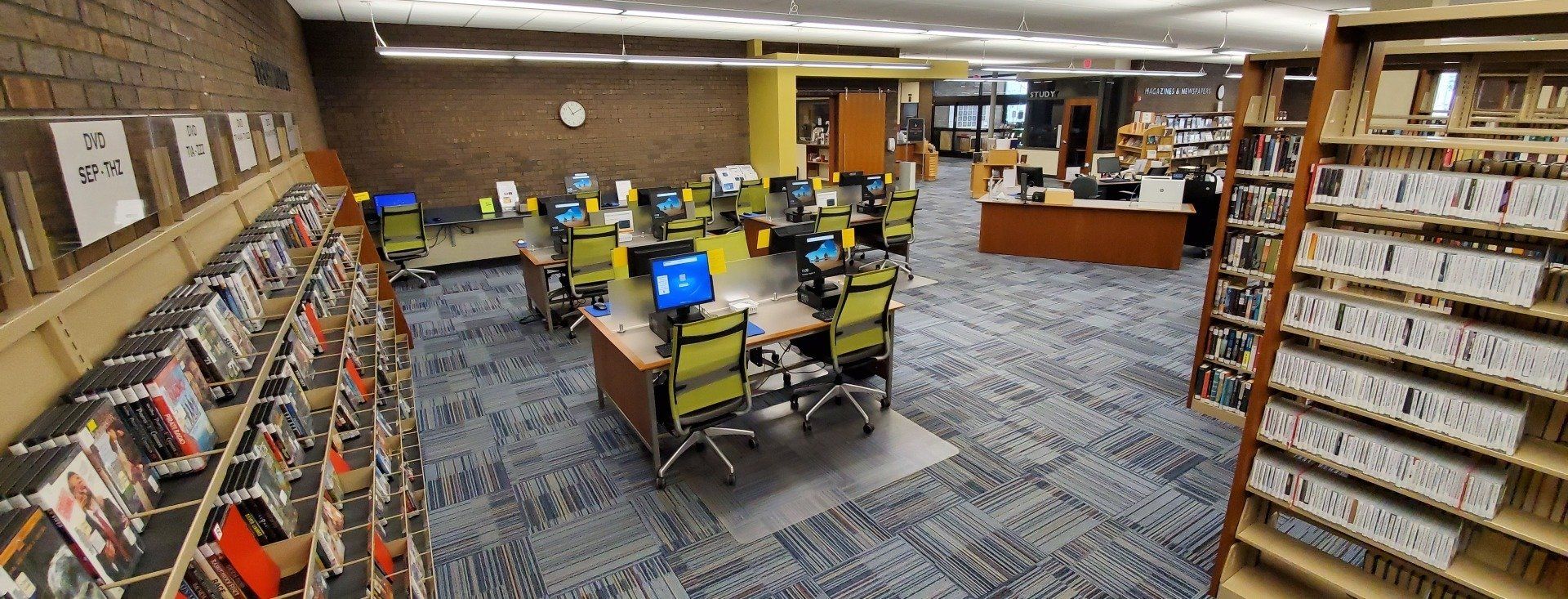 A library filled with lots of books and computers.