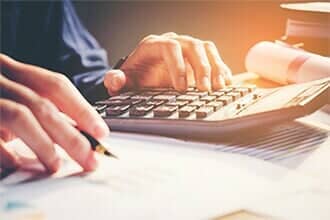 Businessman's hands with calculator - Payroll Company in Yarmouth, ME Businessman's hands with calculator - Payroll Company in Yarmouth, ME