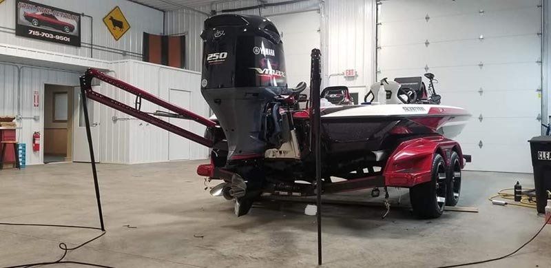A boat is sitting on a trailer in a garage.