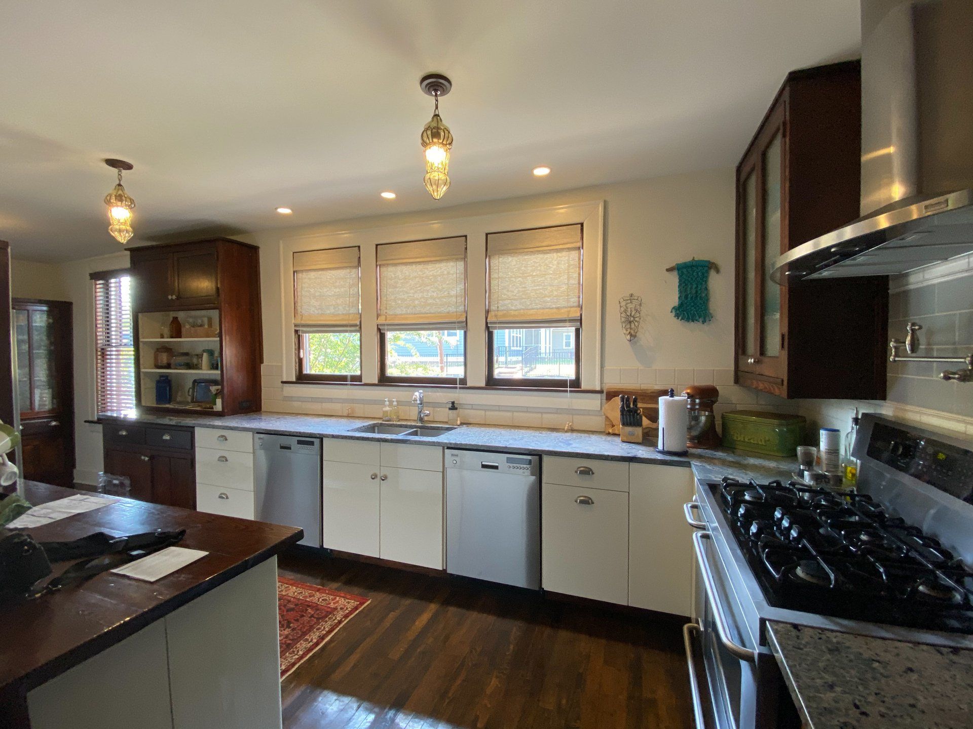 A kitchen with stainless steel appliances and white cabinets