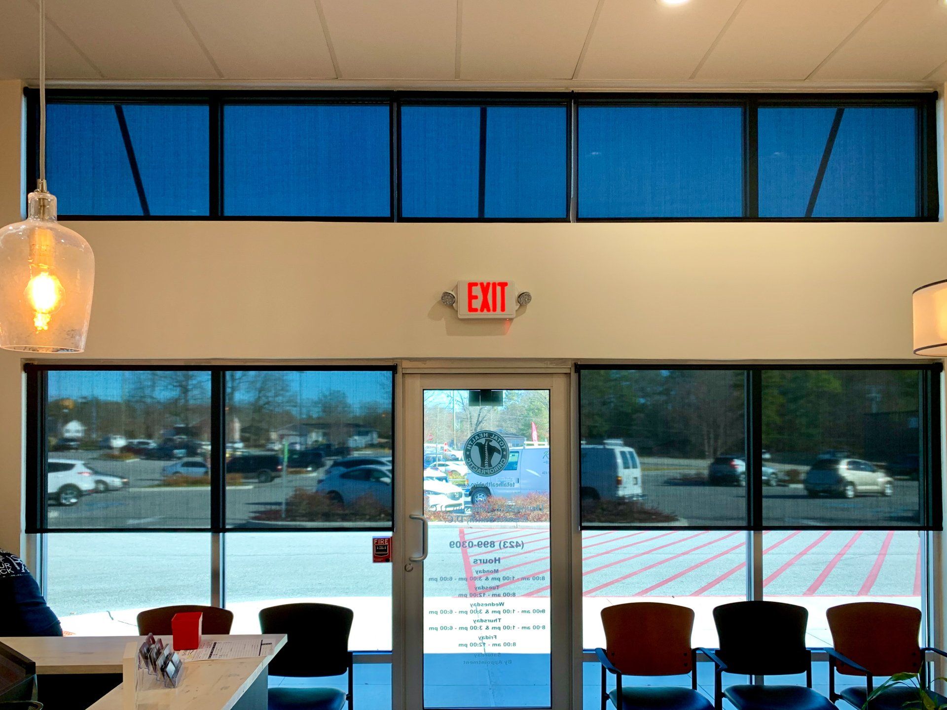 A red exit sign is above a door in a building