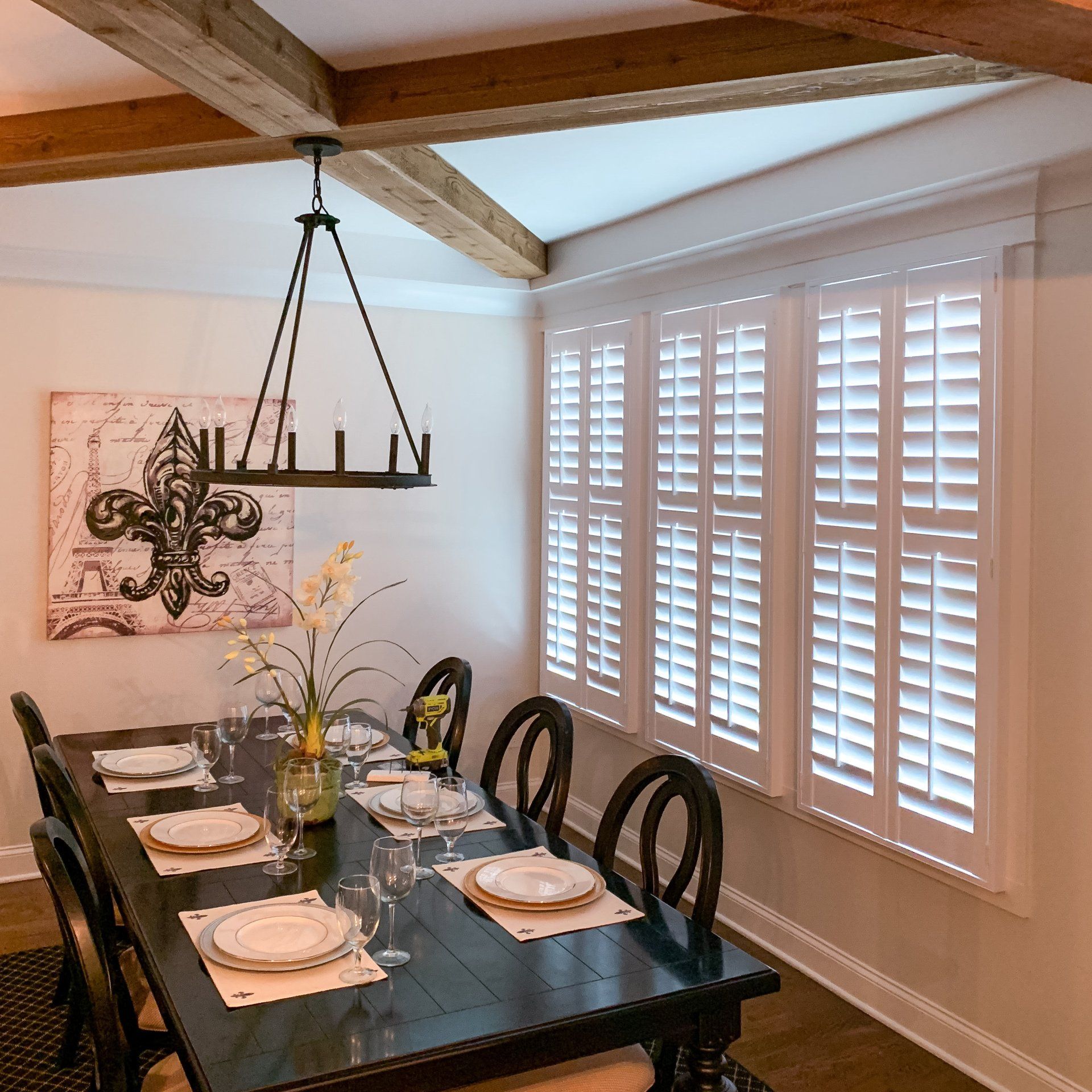 A dining room table with plates and glasses on it