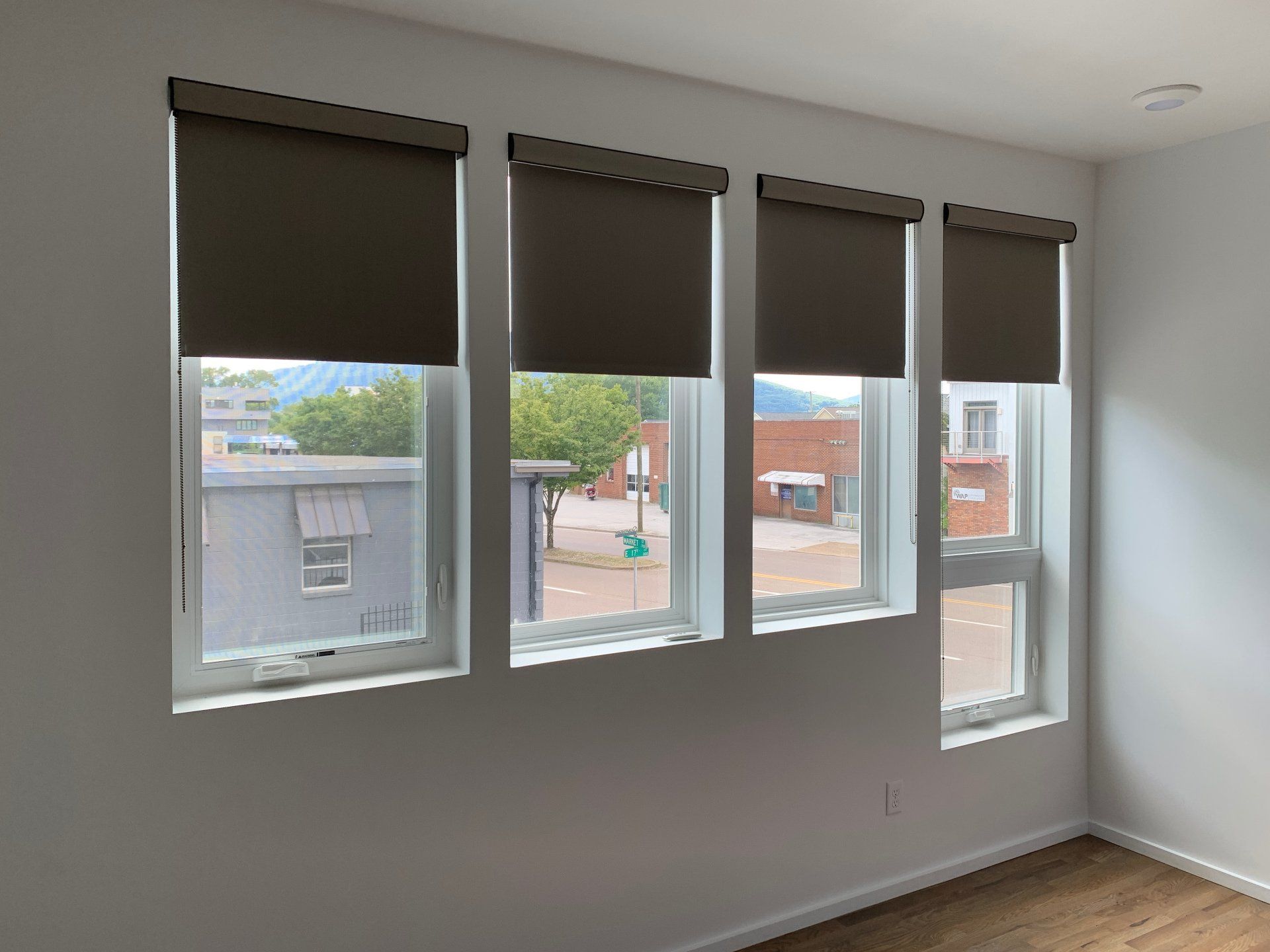 A room with a lot of windows and blinds on them