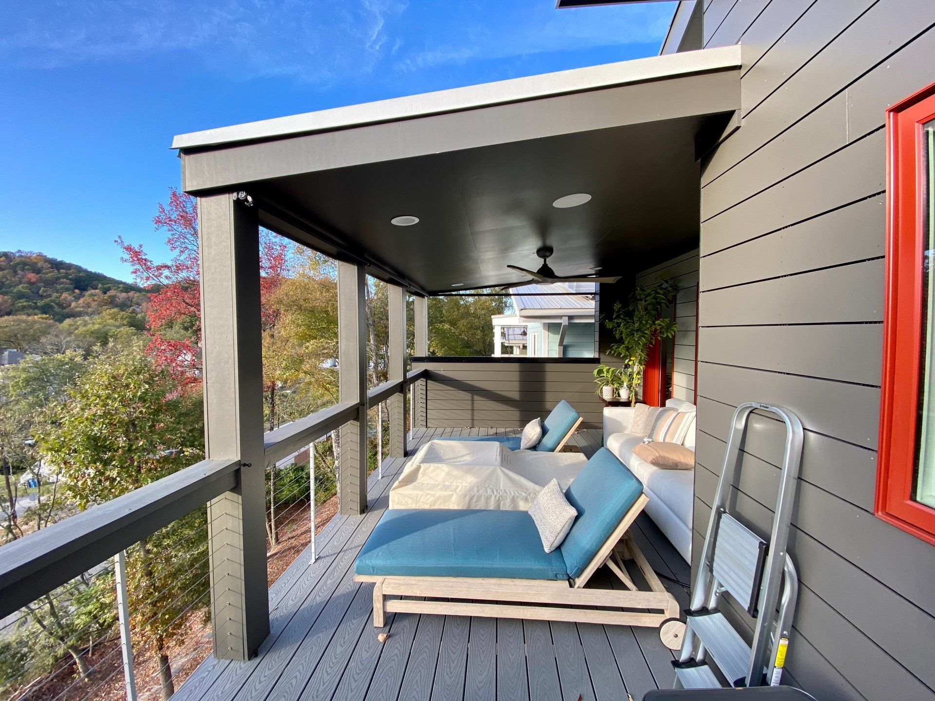 A screened in porch with lounge chairs and a couch