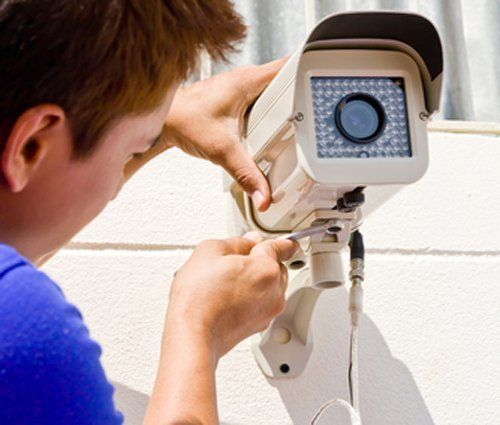 tecnico installa telecamera di videosorveglianza