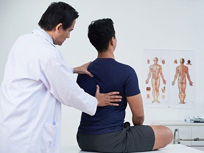 Chiropractor — Chiropractor Examining His Patient in Arcadia, CA Chiropractor — Chiropractor Examining His Patient in Arcadia, CA