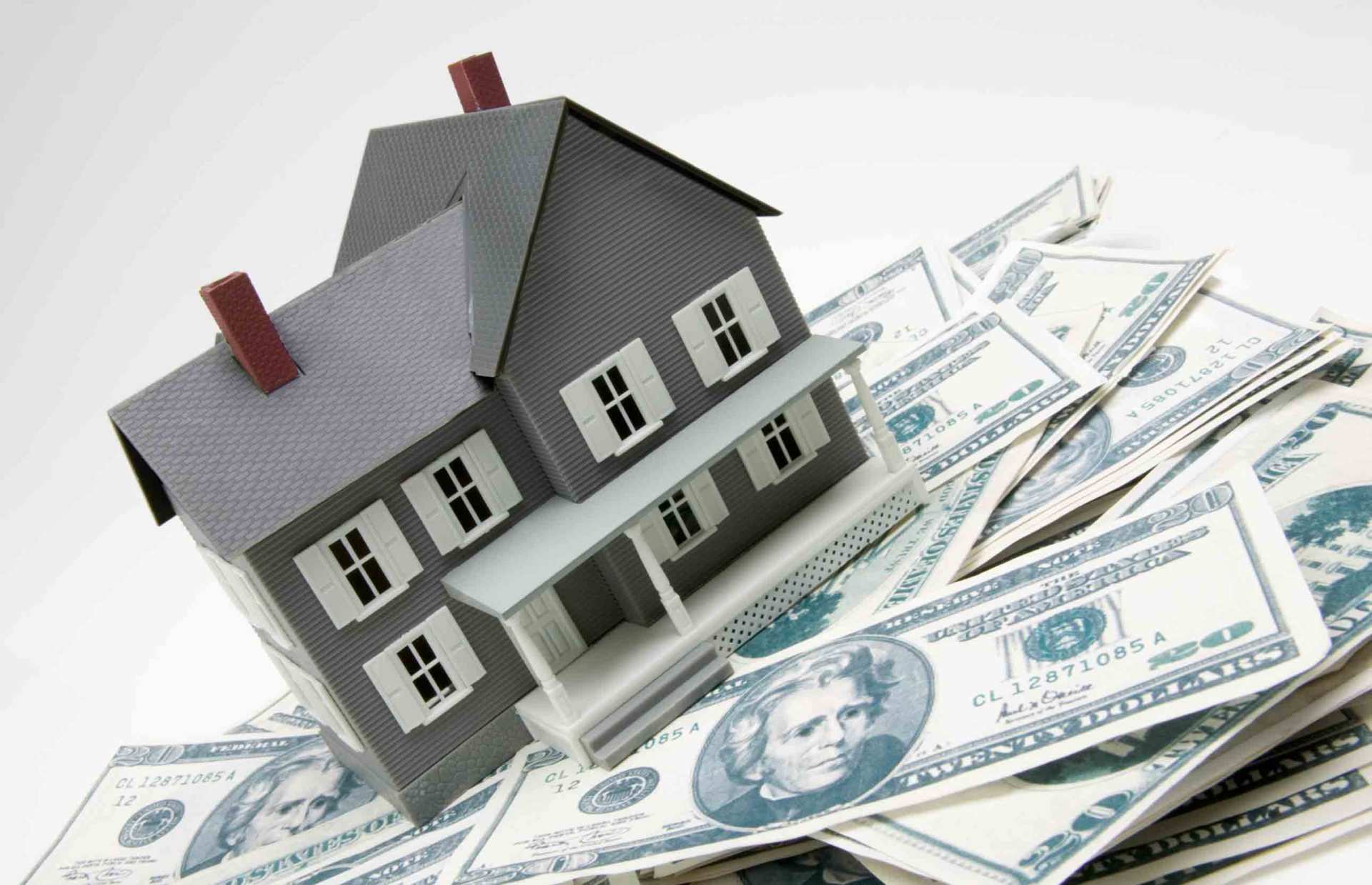 house sitting on pile of money