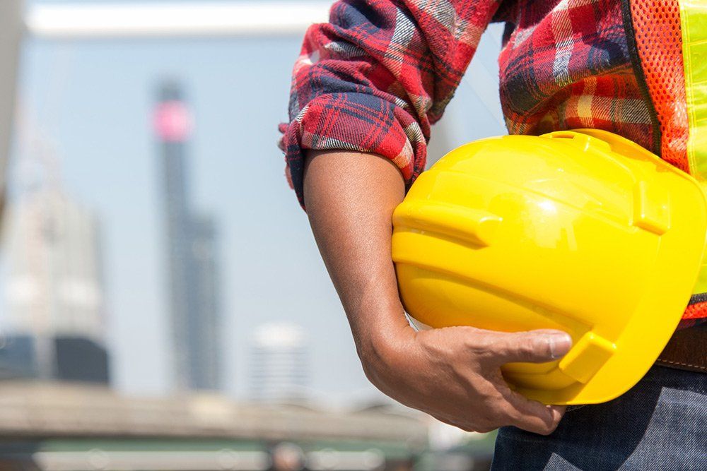 Distribution Careers — Worker Holding Yellow Helmet in Miami, FL Distribution Careers — Worker Holding Yellow Helmet in Miami, FL