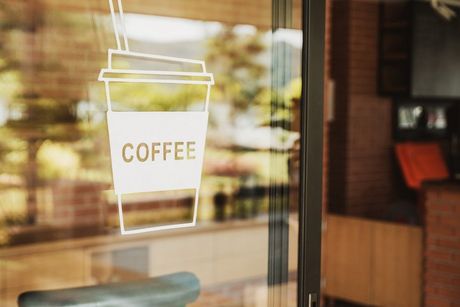 Luxury coffee shop sign on the glass door.