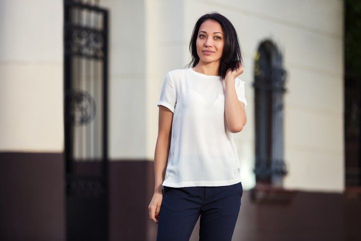 Young woman in white t-shirt on city street
