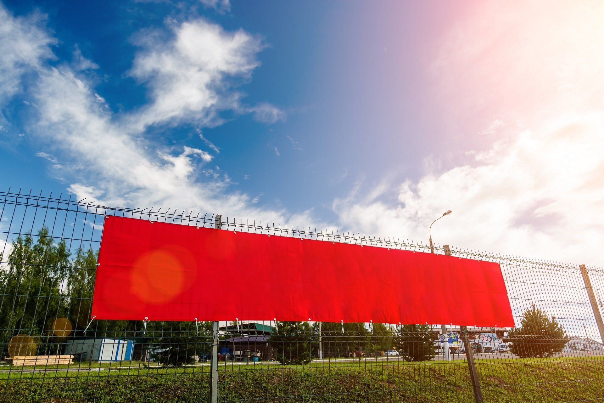 Red banner hanging from fence