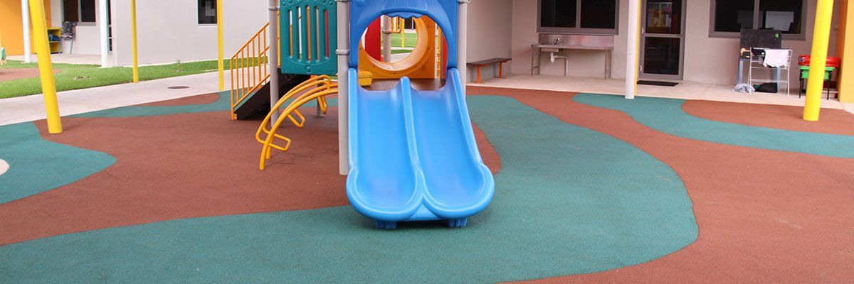 Brown and Blue soft impact material under a playground - Softfall NT (Close-up) Brown and Blue soft impact material under a playground - Softfall NT (Close-up)