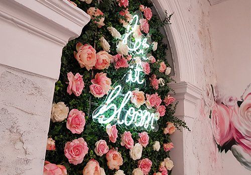 neon sign between roses