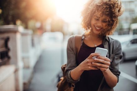 woman contacts her property management company from her mobile phone