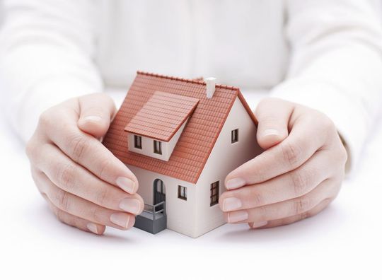 Man holding house