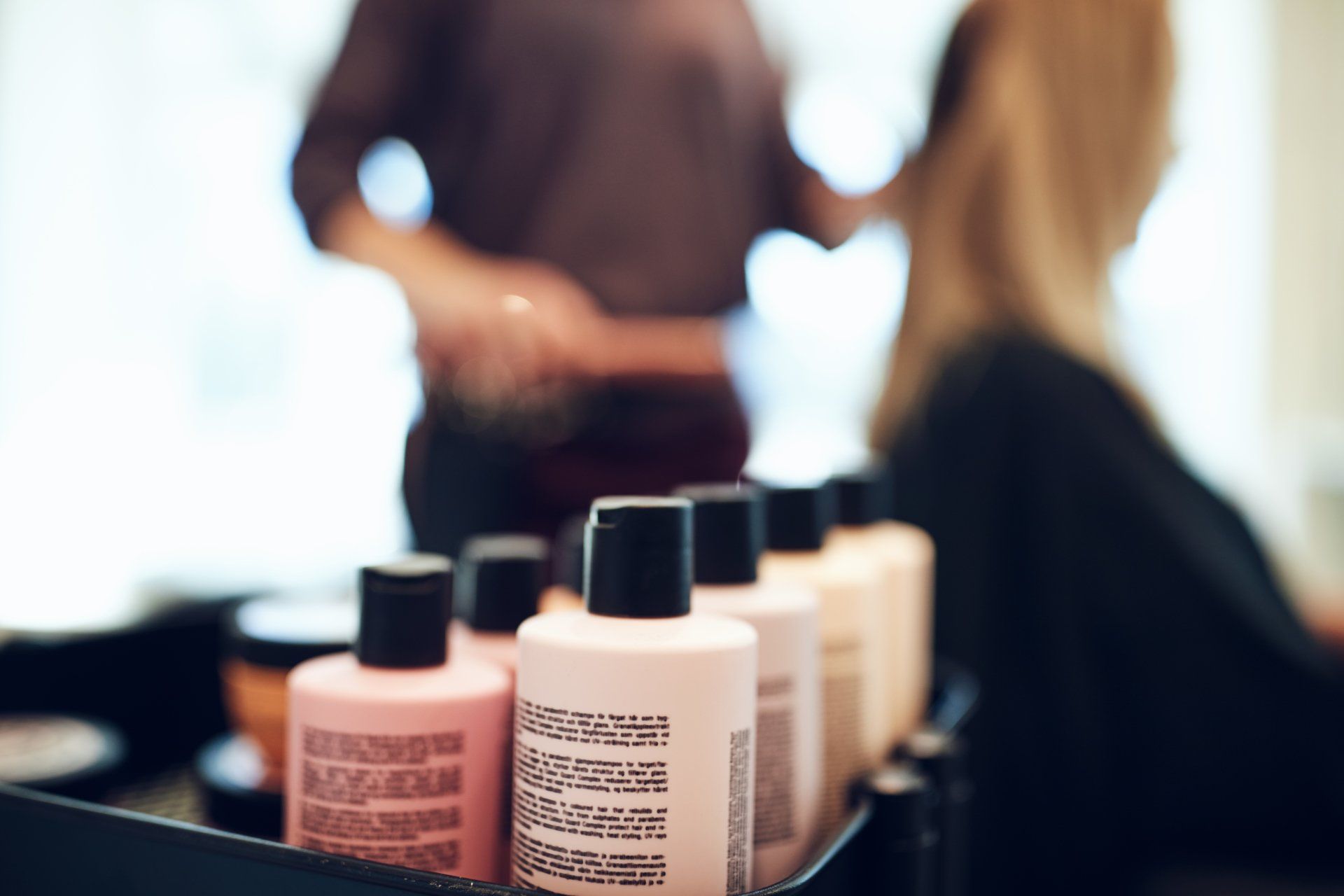 a woman is getting her hair done at a salon