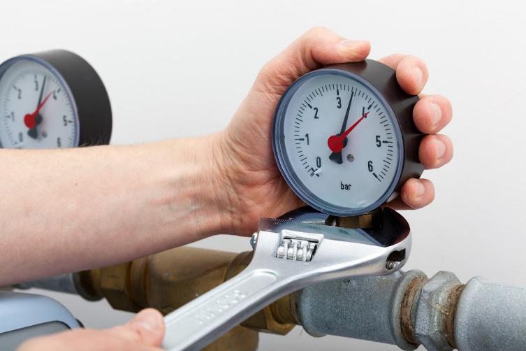 Slab Leaks Prevention — Man Repairing Gauge in Irving, TX