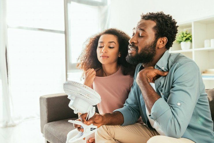 HVAC Tips — Father and Daughter Using Mini Fan in Irving, TX