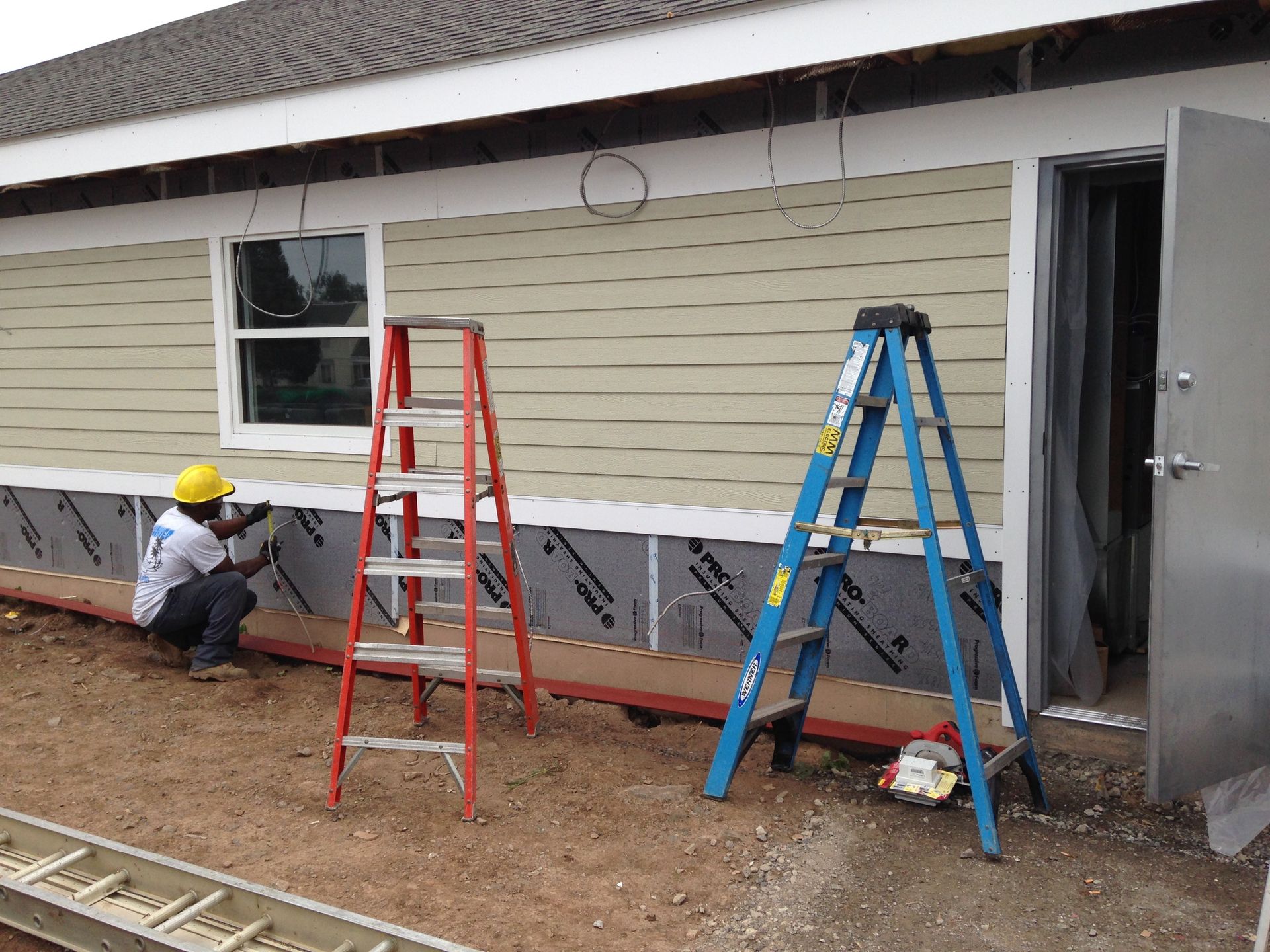 electrician working on exterior of home