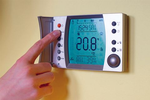 Closeup of a woman's hand setting the room temperature - Heating & Air Conditioning Services in Annapolis, Maryland, Closeup of a woman's hand setting the room temperature - Heating & Air Conditioning Services in Annapolis, Maryland,