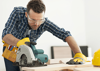Carpenter with Saw - JC Constructions