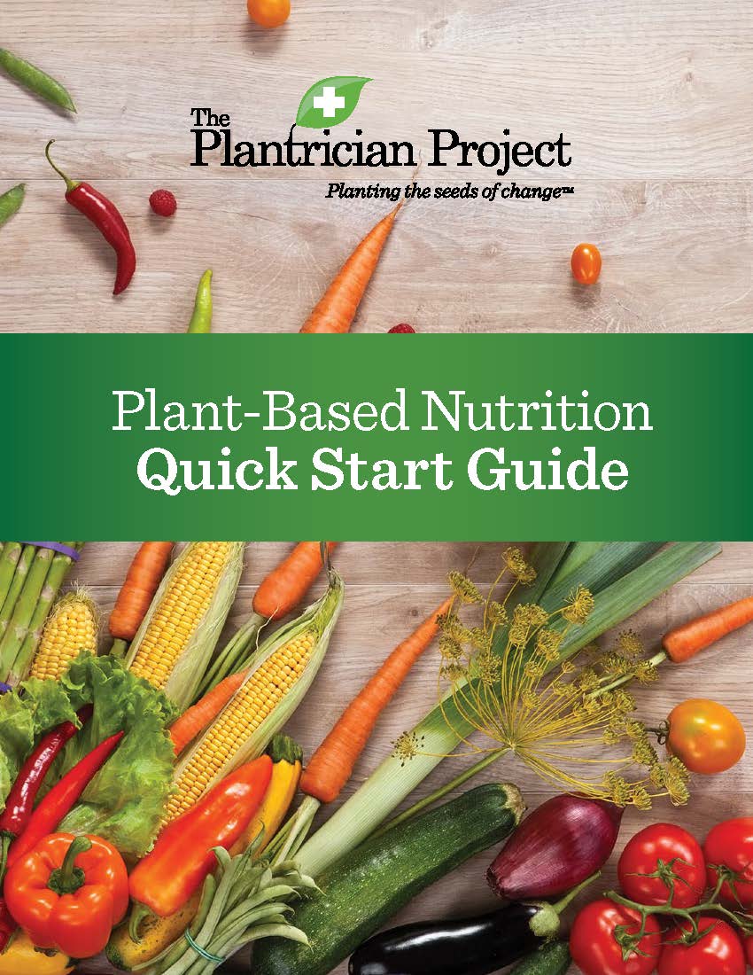 Cover of a plant-based nutrition guide with fresh produce scattered on a wooden surface.