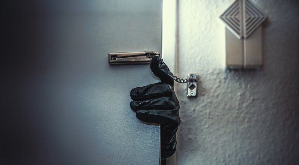 hand peaking through door with lock