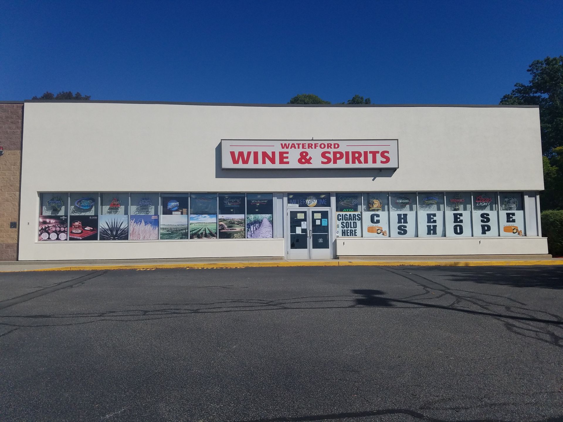 Waterford's Wine & Spirits store exterior with large windows and a sign on a sunny day.