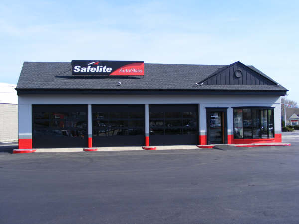 Safelite auto glass repair shop exterior with gray and red accents on a sunny day.