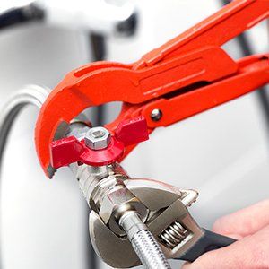 Plumber Screwing Plumbing Fittings—Water Heater Installation in Newburgh, NY Plumber Screwing Plumbing Fittings—Water Heater Installation in Newburgh, NY