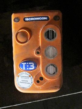 Orangefarbener Crowcon T3 Gasdetektor mit rundem Knopf, drei Sensorgittern und blauem T3-Aufkleber.